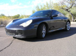2004 Porsche 911 Carrera 4S in Atlas Grey Metallic parked outdoors, showcasing sporty design and features.