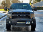 Front view of a 2014 Ford F150 FX4 Supercrew Cab with a rugged appearance and clean title.