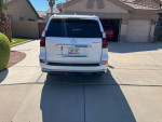 Rear view of a 2019 Lexus GX 460 parked in a driveway, showcasing its luxury design and clean condition.
