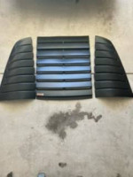 Parts for 1985 Chevrolet Corvette with original miles, including ground effect pieces and side exhaust.