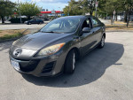 2010 Mazda 3 with 184k miles parked, featuring Bluetooth and cold A/C in excellent condition.