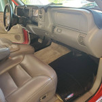 Interior view of a well-maintained 1999 Chevrolet Tahoe 2dr SUV with beige leather seats and dashboard.