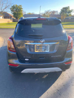 Rear view of a 2017 Buick Encore Premium FWD parked, showcasing its sleek design and excellent condition.