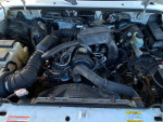 Under the hood of a 2000 Mazda B2300 showing engine components and repairs needed.