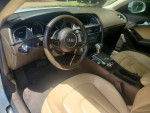Interior view of a 2013 Audi A5 with leather seats and modern dashboard features.