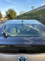 Rear view of a 2014 Toyota Prius with excellent exterior condition and features like cruise control and Bluetooth.