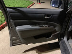 Interior view of a 2010 Toyota Prius showing door features and controls