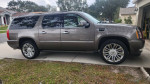 2012 Cadillac Escalade ESV Luxury with bronze exterior, parked on driveway, showcasing its stylish design and features