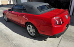 2012 Ford Mustang convertible in red, showing rear and roof, excellent condition with clean title and 130k miles.