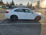 2013 Chrysler 200 in white, 3.6L V6 engine, parked in a lot, showing side view