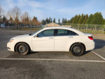 2013 Chrysler 200 in white, featuring a 3.6L V6 engine and 94,850 KM, parked in a lot.