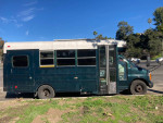 2002 Chevy Bluebird school bus conversion with diesel engine, recently updated, parked outdoors