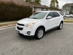 White 2011 Chevrolet Equinox LT parked outdoors, showcasing sleek design and clean exterior.