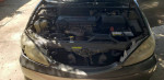Under the hood of a 2005 Toyota Camry showing the engine and components with low mileage of 53,000 miles.