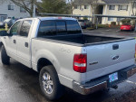 2008 Ford F150 XLT 4X4 short bed pickup truck parked, showing some rust on rear cab corners.
