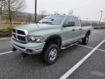 2003 Dodge Ram 2500 Diesel truck in a parking lot, fully restored with new paint, tires, and transmission.