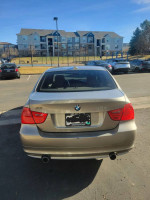 2010 BMW 3 Series 335i sedan rear view in excellent condition, showcasing sporty features and clean title.
