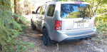 2013 Honda Pilot in nature, clean with 57,000 miles, featuring 4WD and spacious interior for eight passengers.
