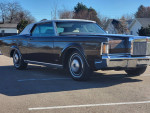 1970 Lincoln Continental Mark III in a parking lot, showcasing its classic design and chrome accents.