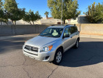 2010 Toyota RAV4 in silver with 58,000 miles, parked on a street, showcasing its reliable features and clean exterior.