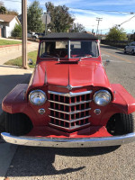 1950 Willys Jeepster Resto rod with modern upgrades and a classic red exterior.