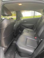 Interior view of a 2020 Toyota Corolla Hybrid with leather seats, ideal for driving school or daily use.