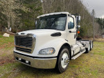 2007 Freightliner M2 truck with new tires and upgraded features, parked in a scenic outdoor setting.