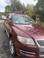 2008 Burgundy Volkswagen Touareg SUV with 100,000 miles parked outdoors