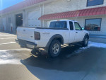 2002 Ford Ranger extended cab 4x4 parked with a timing chain issue, showing rear and side view.