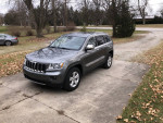 2012 Jeep Grand Cherokee 4x4 Limited parked on driveway, featuring leather interior and towing package.