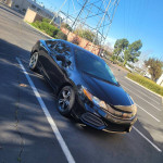 2015 Honda Civic EX in black with 146,000 miles parked in a lot, showcasing clean exterior and modern design.