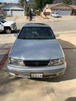 Front view of a well-maintained 1999 Toyota Avalon XLS in silver color, parked in a residential area.