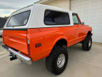1971 Chevy K5 Blazer 4X4 in orange with removable hardtop, showcasing its classic design and robust tires.