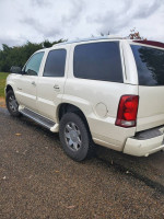2005 Cadillac Escalade SUV in white with all-wheel drive, showcasing its spacious design and rugged tires.