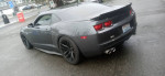 2010 Chevrolet Camaro LS with custom racing suspension and HID lights parked on the street.