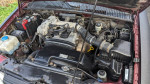 Engine bay of a 2002 Kia Sportage with aftermarket enhancements and maintenance updates.