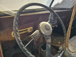Interior view of a 1953 Willy's Jeep Truck showing steering wheel and dashboard details.