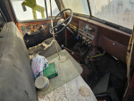 Interior of a 1953 Willy's Jeep Truck showing worn seats and dashboard, for sale at $6500 OBO.