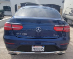 Stunning lifted blue Mercedes-Benz GLC 300 Coupe parked outside, showcasing its sleek design and 4MATIC badge.