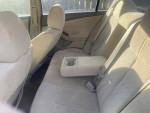 Interior view of a well-maintained 2007 Nissan Altima with beige upholstery and center console