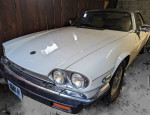 1989 Jaguar XJS project car with low mileage, in good condition but requires repairs, parked in a carport.