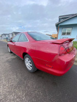 2000 Honda Accord LX red car parked on the street, showcasing its classic design and manual transmission features.