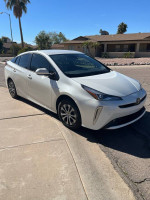2019 Toyota Prius XLE in excellent condition, parked on a sunny street, ready for travel and adventure.