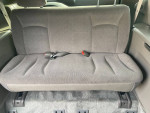 Interior view of a Dodge Caravan's clean rear seat, designed for wheelchair accessibility.