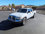 2005 Dodge Dakota SLT Quad Cab V8 in white parked in a lot, excellent condition with low mileage.