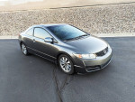 2010 Honda Civic EX Coupe in gray with premium wheels parked on asphalt.