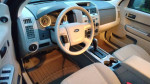 Interior view of a well-maintained 2012 Ford Escape Hybrid with a clean dashboard and seating.