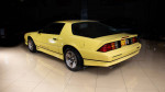 1987 Chevrolet Camaro IROC-Z in bright yellow, showcasing classic design and mirror finish paint.