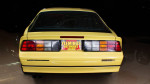 Rear view of a 1987 Chevrolet Camaro Z/28 in original yellow paint with showroom finish.