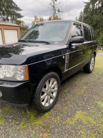 2006 Land Rover Range Rover with new features and 100,000 miles, showcased outdoors on gravel.